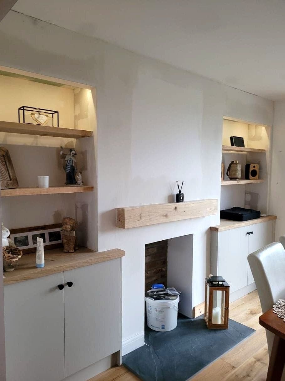Alcove shelves lit and dressed either side of an oak mantel