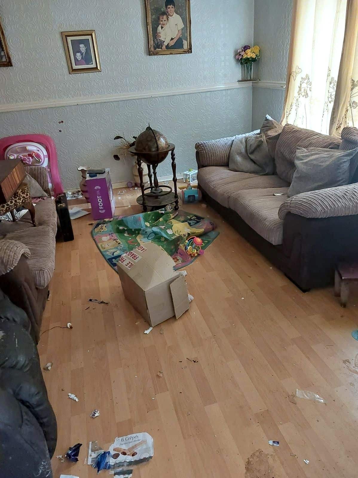 Living room as found: sofas, toys and rubbish across the floor