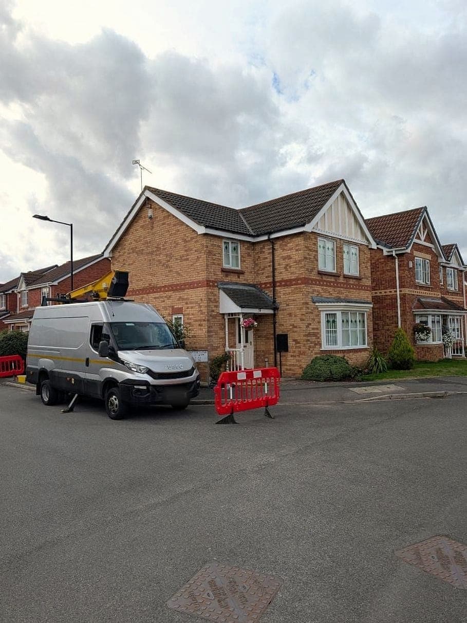 DBF's own cherry picker on its van, parked beside a house with barriers out