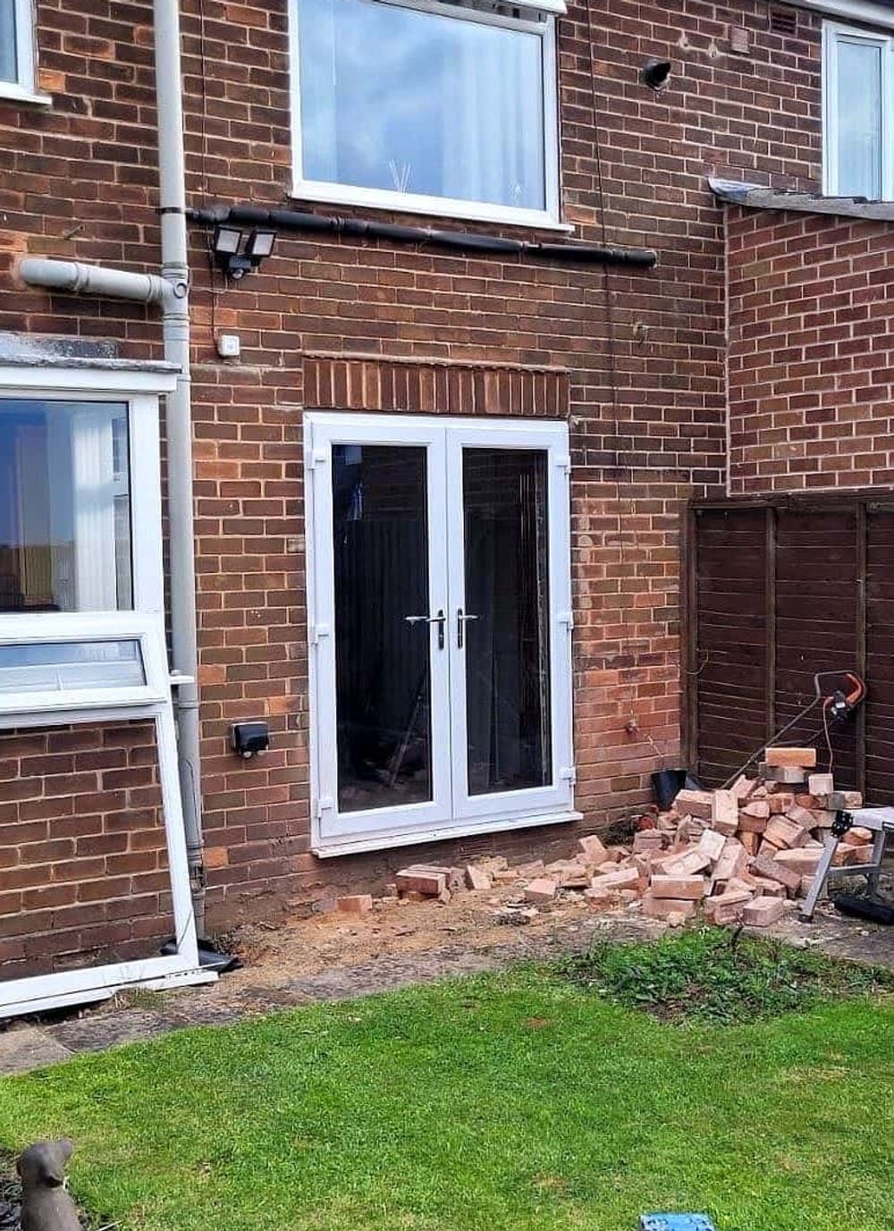 The same rear wall with white French doors fitted in the opening